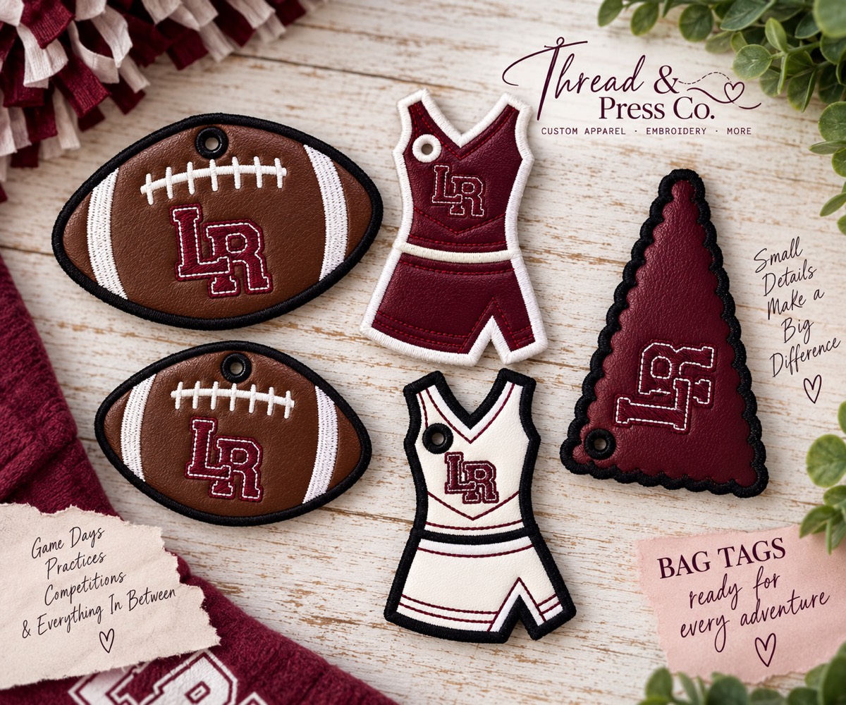Embroidered bag tags shaped like footballs, cheer uniforms, and a pennant, all in maroon with the LR team logo