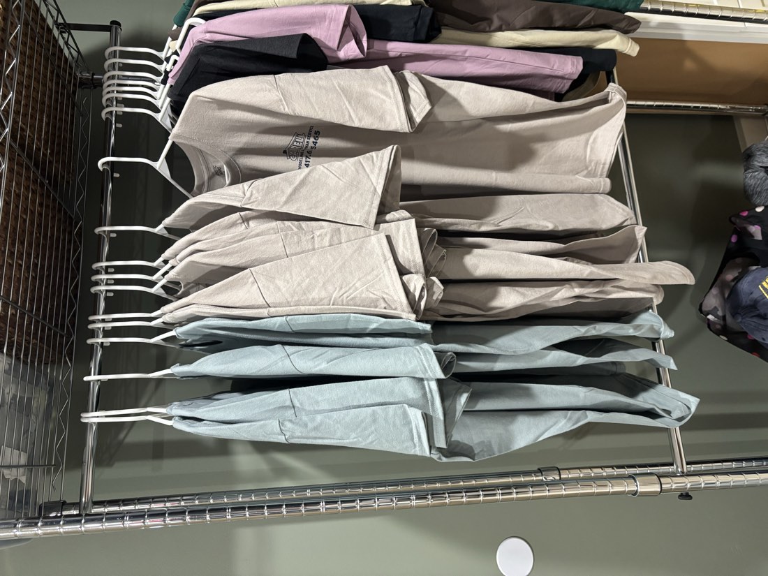 Rack of shirts hanging in the shop, ready for customer orders