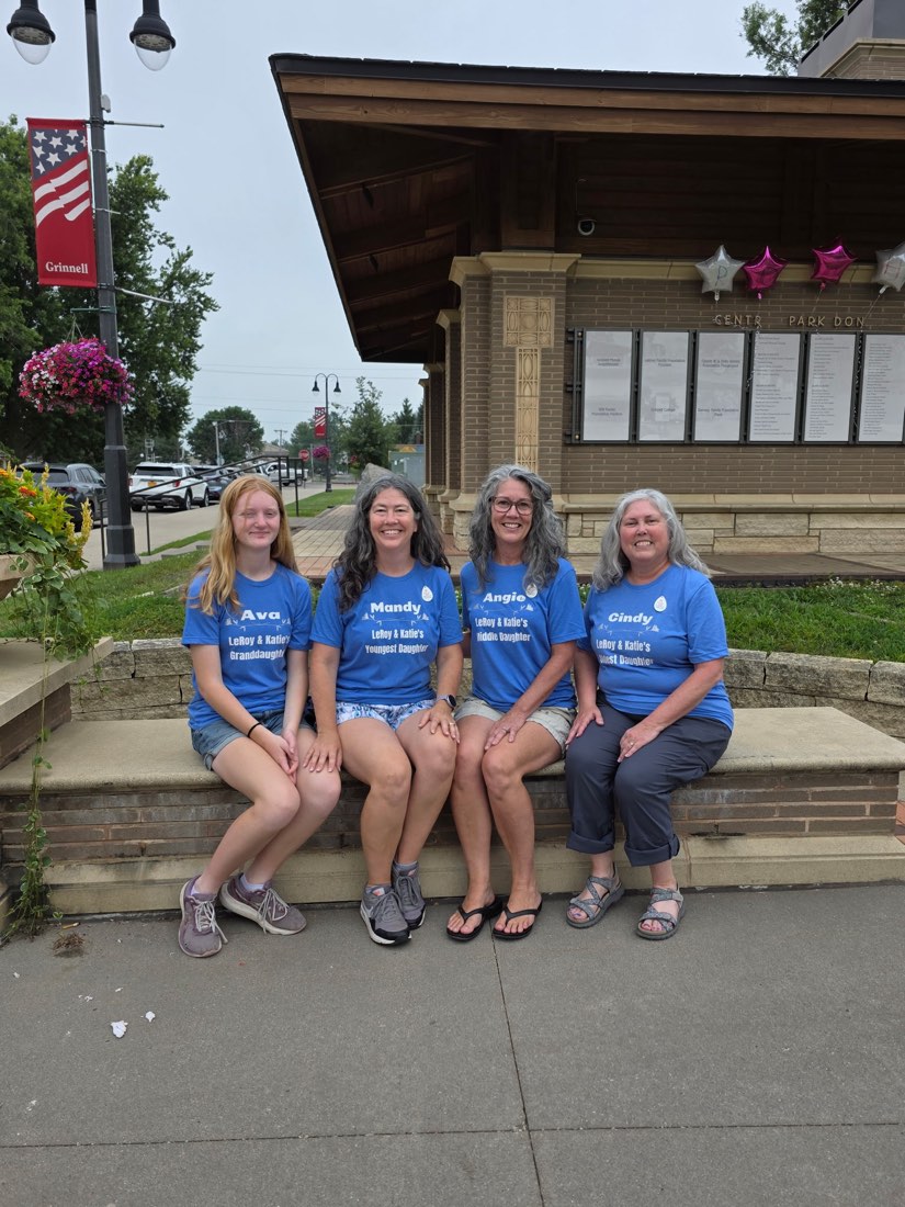 Four family members outdoors wearing matching personalized blue reunion shirts